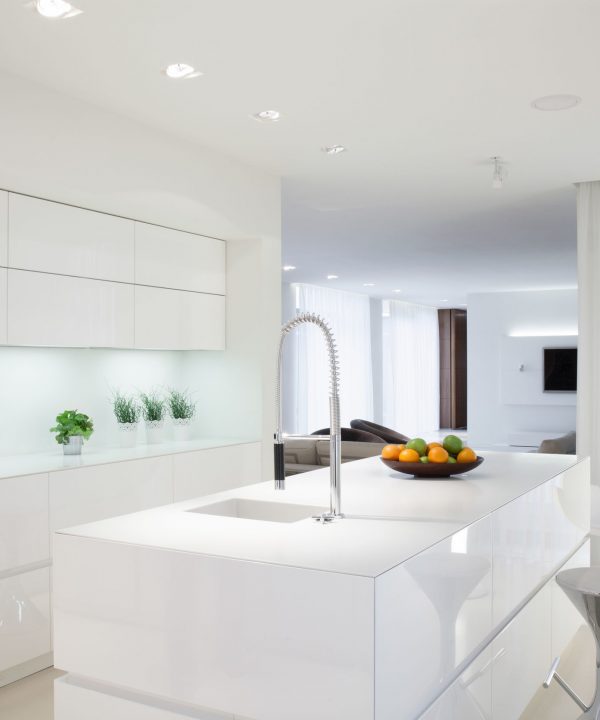 White clean kitchen with island in the middle